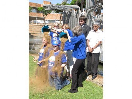 Councillors Stefanie Kruger and Jackie Reilly subjected themselves to sand being poured over their heads by fellow councillors, Tania Campbell, Jill Humphreys and Ashley Rutherford, outside the monthly council meeting.