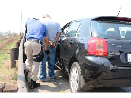 An EMPD officer searches the suspected car thief, after he was cornered in Wadeville, last Tuesday.