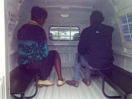 These two women, who were recently arrested on charges of soliciting/importuning for the purpose of sexual immorality, were transported to the Primrose Police Station in the back of an official police van.