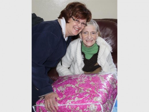 Netcare Sunward Park Hospital emergency department unit manager Cheryl Nagel (left) presents Kowa Pienaar resident Amanda van der Walt with her gift.