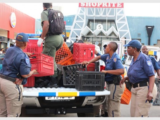 The crates and wares seized being loaded onto an EMPD vehicle.