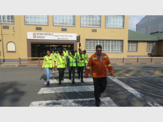 The girls go on a tour of Scaw Metals with Eddie Botes (front).