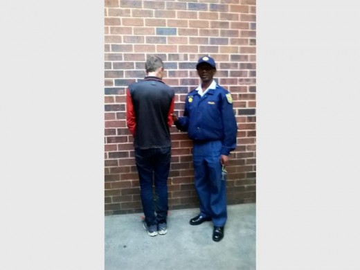 This 30-year-old man was recently arrested by the Primrose police after he was found in possession of an unlicensed firearm and ammunition. Here Sgt Vincent Nkosi watches over the suspect.