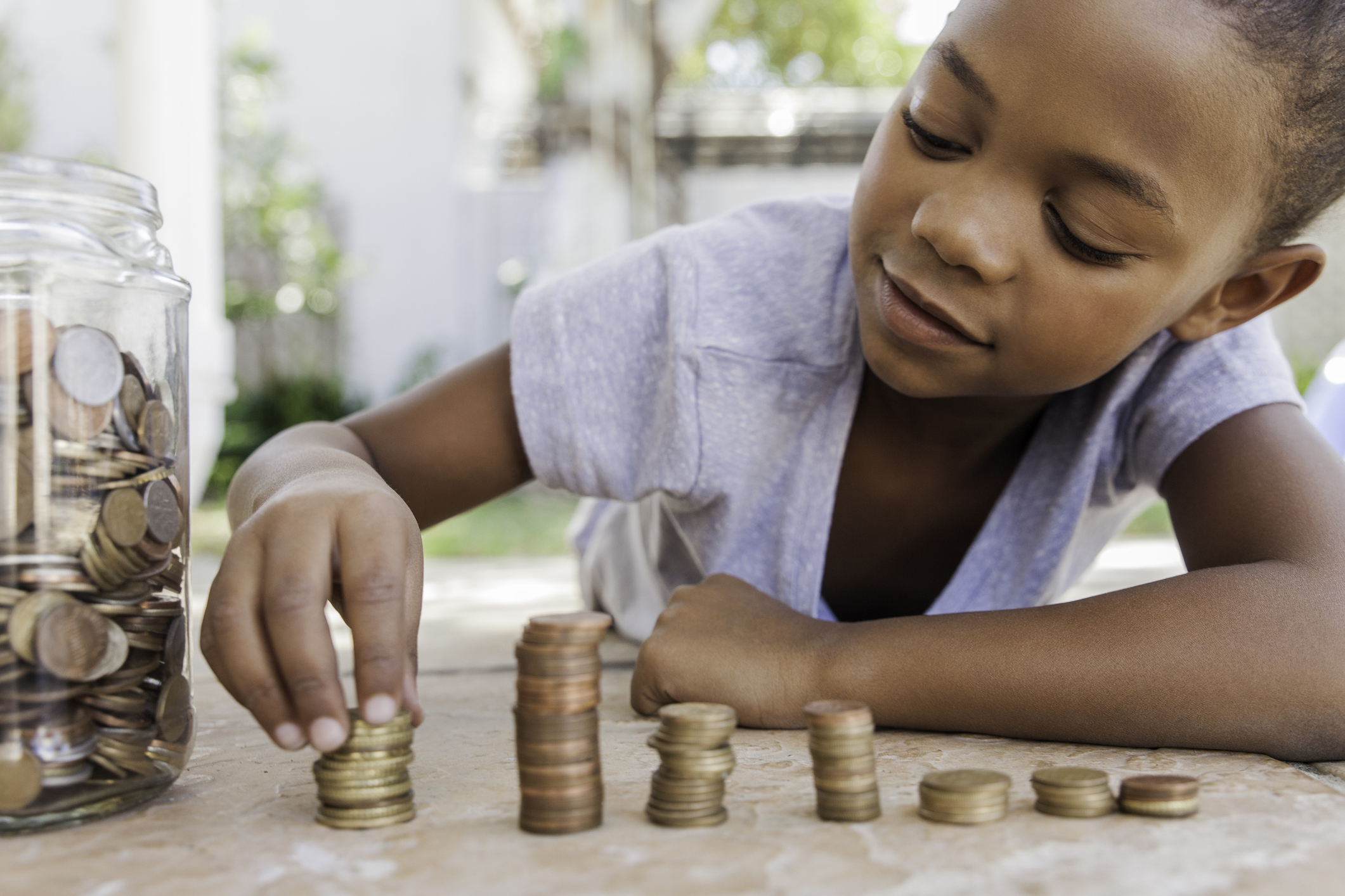 Young girl counting her coins.