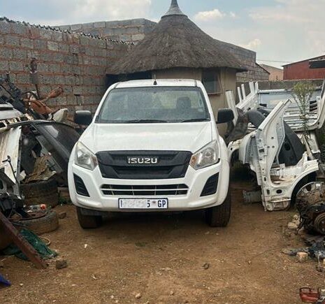 During the inspection, officers discovered a white Isuzu pickup truck parked in the backyard with false registration plates affixed to the vehicle.