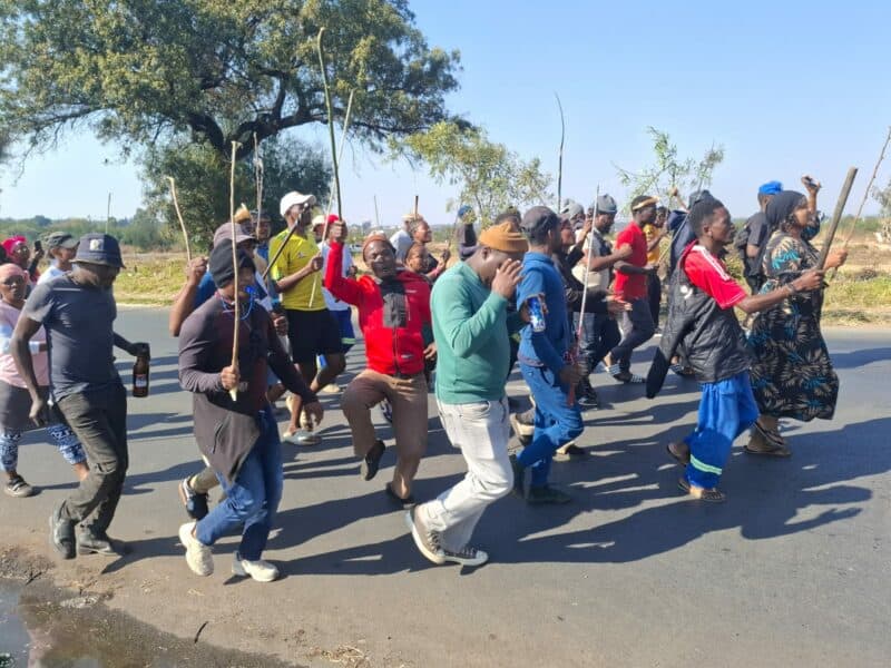A group of demonstrators is currently moving along Pretoria Road towards Shamrock Road. The group proceeded down Rietfontein Road before turning onto Cactus Road and then right onto Pretoria Road. They are being monitored by a strong law enforcement presence, including SAPS and private security.