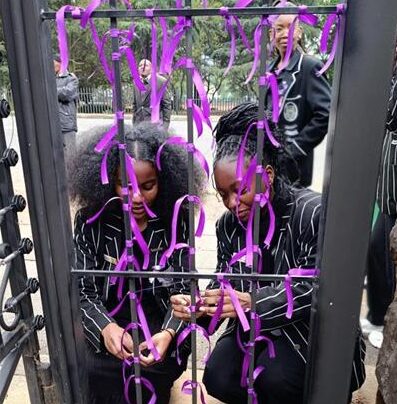 The Jeppe High School for Girls community paid tribute to victims of gender-based violence by wearing black and creating a purple ribbon memorial at the school’s main gate.