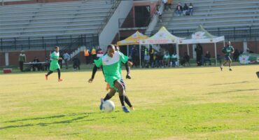 A group of young men playing soccer on a field.