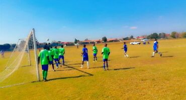 A group of young men playing soccer on a field.
