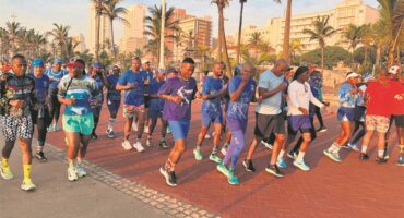 A group of people running on a brick path.