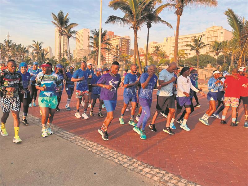 A group of people running on a brick path.