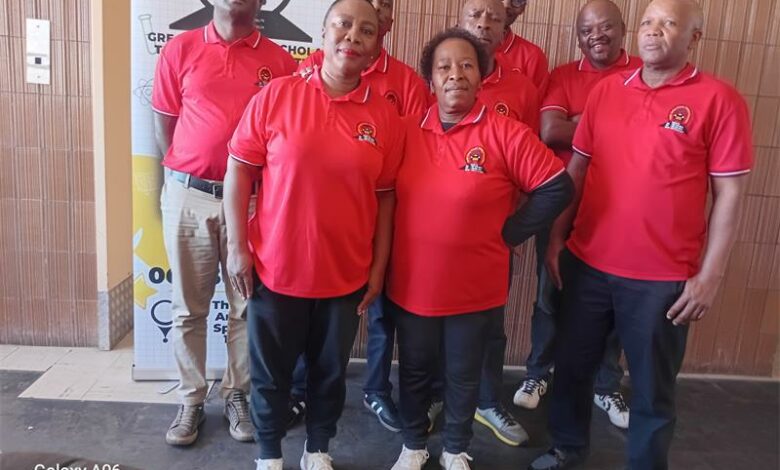 A group of people in red shirts posing for a photo.