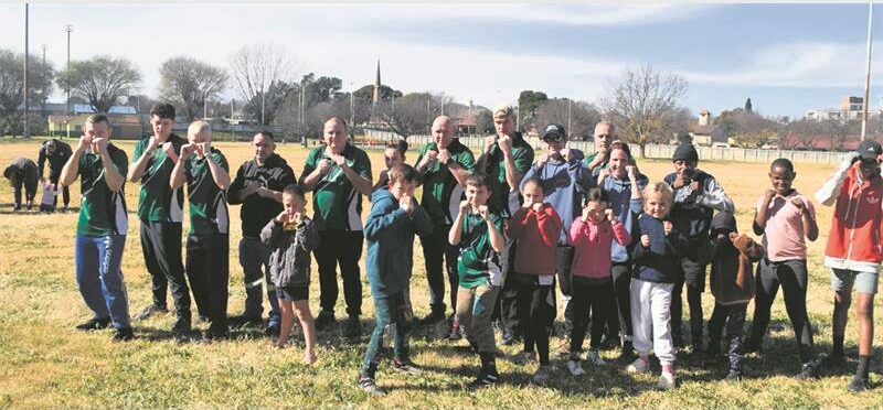 A group of people posing for a photo on a field.