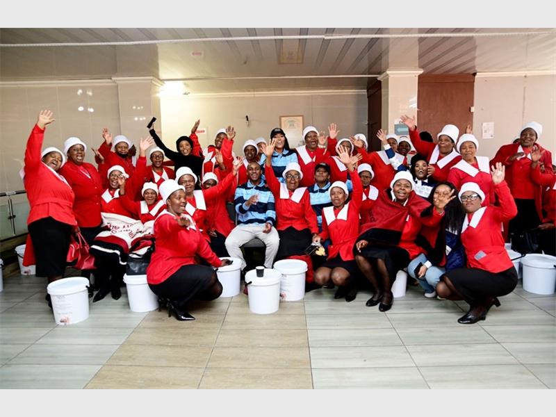 A local law firm marked Mandela Day by returning to a church that supported them in their early years and handing out food parcels to those in need.