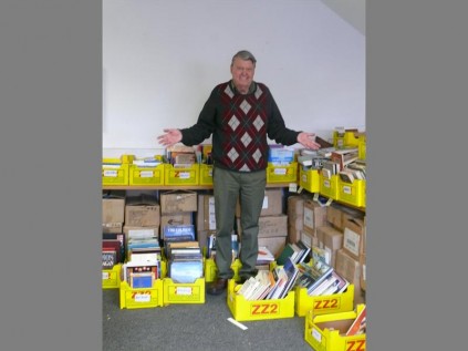 Books to sell... Keith Elliot of Friends of the Library is surrounded by crates of books for sale.