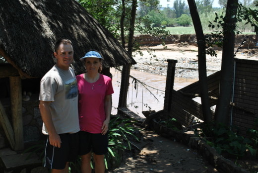 Derik and Riekie Swanepoel in front of the wall that was washed away.