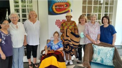 A group of elderly people posing at the event for a picture