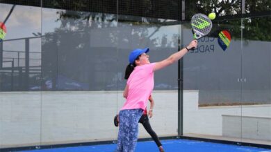 Tammy Ho jumps to hit the tennis ball.