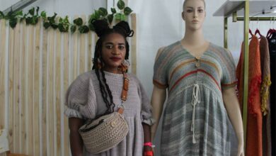 Phillioine Ermi Mabanga stands next to her designs.