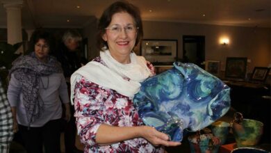 Louise Howard shows off her art.