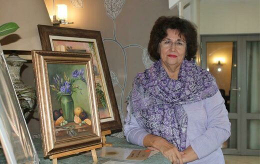 Carla Monni poses next to her art.