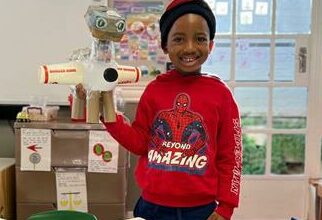 Akani Mnisi shows a paper animal he made during class.