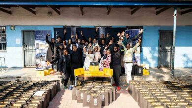 The Flanagan and Gerard team handing out Bathu shoes to the pupils at the Realogile Secondary School in Alexandra