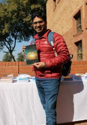 Gauran Khan Delwal shows off his copy of Andhakar Se Ujale Ki Ore (Going from Darkness to Light). Photo by: Lebogang Tlou