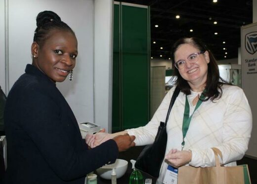 Enifa Sibanda rubs an organic lotion on Felicity Cook's arm to test its moisturising effect. Photo: Duduzile Khumalo