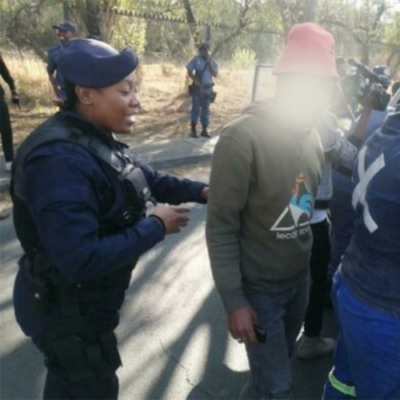 Police officers search vehicles during Operation Shanela. 