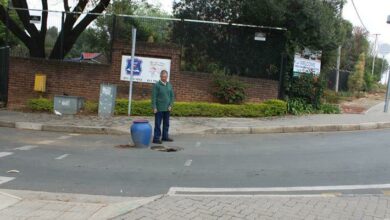 Jack Patel points to the missing manhole cover that was mysteriously replaced overnight. Photo: Duduzile Khumalo