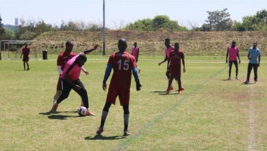 Saints (pink) player Delphin Tonton attempts to break through Chaimlos's defence formation manned by Bongani 'Drogb' Ndulula (behind Tonton) and Mtokhozizi Nkomo (15).