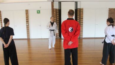Ognjen Bozic explains his philosophy to the October 7 class's black belt students Michaela Wilson, Dylan Wilson and Kathleen Elder.