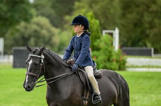 Nine-year-old Layah Gliksman celebrates champion titles after a week of dedication, teamwork, and a special bond with her ponies.