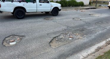 Motorists navigate multiple potholes along a damaged section of 1st Avenue in Kew in May 2026. Photo: Duduzile Khumalo