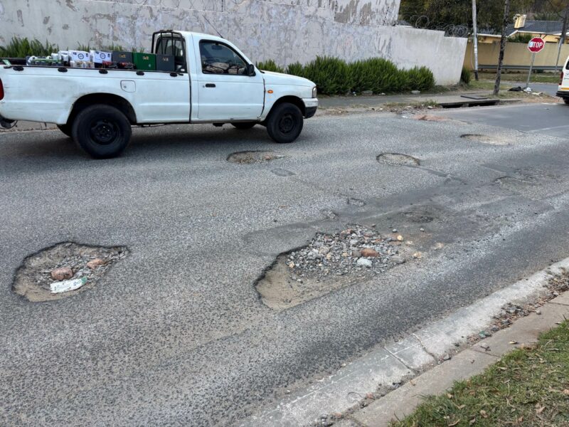 Motorists navigate multiple potholes along a damaged section of 1st Avenue in Kew in May 2026. Photo: Duduzile Khumalo