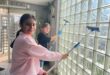 Ruhani Kapoor and Emily Johnes-Wadge help wash the windows at Sandton Police Station on July 18, 2026.