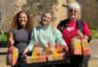 Volunteers Mia Rogers, Gabriela McKinnon and 67 Blankets ambassador Jo Corlett help spread warmth and kindness by handing out bread, biscuits and handmade knitted items to passers-by as part of the annual Mandela Day initiative. Photo: Xoliswa Zakwe