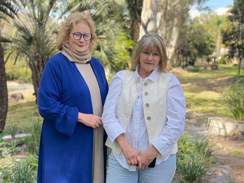 Ward 109 councillor Lori Coogan and Edenburg resident Joy Stewart stand alongside the Sandspruit River, where recurring sewage spills have become a source of frustration on August 13, 2026. Photo: Xoliswa Zakwe