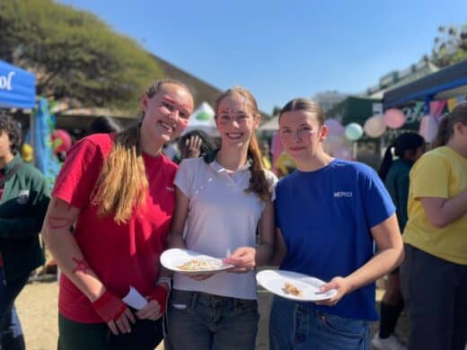 Jade Herwill, Ella Gay, and Caragh Blane enjoy treats while exploring the stalls at Brescia House School's August Rush Market Day on August 4, 2026. Photo: Xoliswa Zakwe