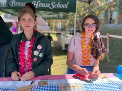 Arianna Buchhold and Rebecca Sears prepare handmade personalised jewellery at their stall at Brescia House School's August Rush Market Day on August 4, 2026. Photo: Xoliswa Zakwe