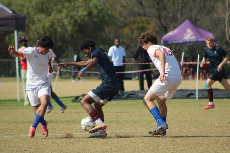 St Benedict’s Nathan Ross and Cristiano Correia with St John’s Kwandi Ngcobo battle for possession in the U19 finals of the St Davids Challenge Cup on August 9, 2026. Photo: Xoliswa Zakwe