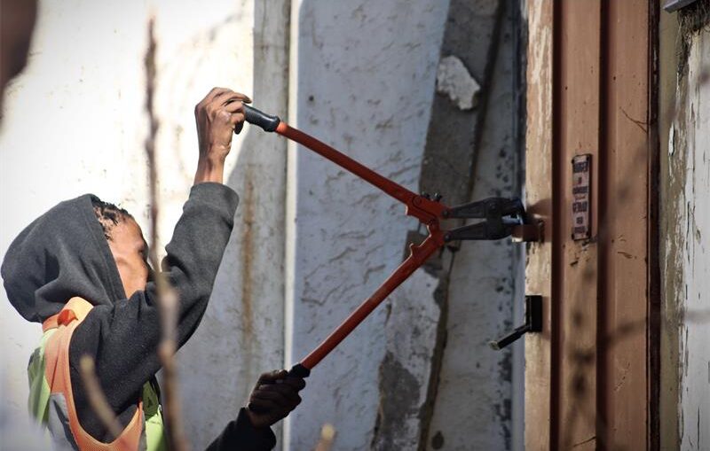 A City Power worker uses heavy-duty cable cutters to remove or dismantle a secured structure on August 13, 2026. Photo: Itumeleng Maloka
