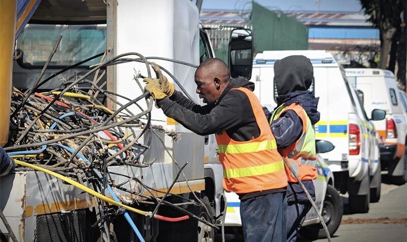 A City Power worker carefully handles a tangled mass of cables during the operation on August 13, 2026. Photo: Itumeleng Maloka