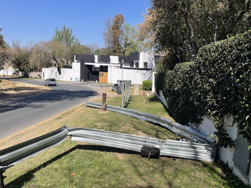 Sections of the guardrail lie damaged along the grass verge on St Audley Road after a vehicle crashes at the bend on August 25, 2026. Photo: Xoliswa Zakwe