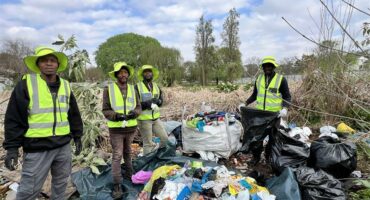 Simo Ngqulunga, Michael Nku, Mike Ncube and Sthandile Daluka work through overgrown vegetation and litter as part of an effort to restore the popular dog-walking area and improve the condition of the natu