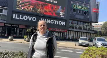 Illovo resident Helien Gous stands outside Illovo Junction, where she says the giant digital billboard has caused years of frustration for nearby residents and motorists travelling along the corner of Corl