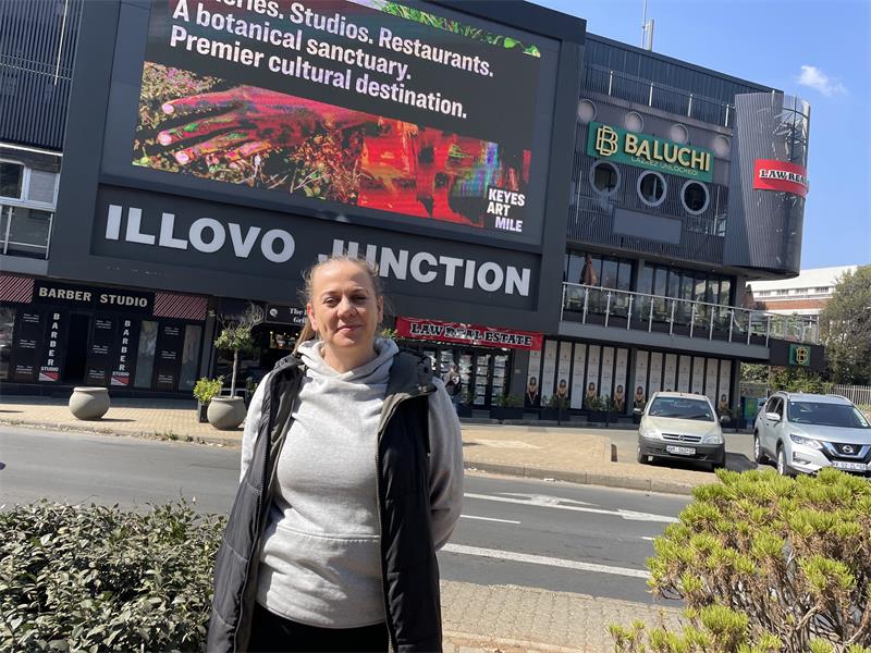 Illovo resident Helien Gous stands outside Illovo Junction, where she says the giant digital billboard has caused years of frustration for nearby residents and motorists travelling along the corner of Corl