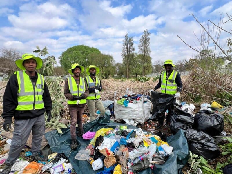 Non-profit organisation partners with dog walkers and residents to clean up a neglected local nature space.