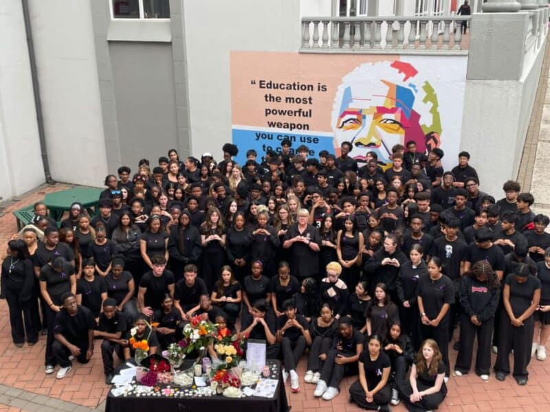Learners and staff dressed in black and wore purple ribbons as they gathered to support mourning families and call for an end to violence.